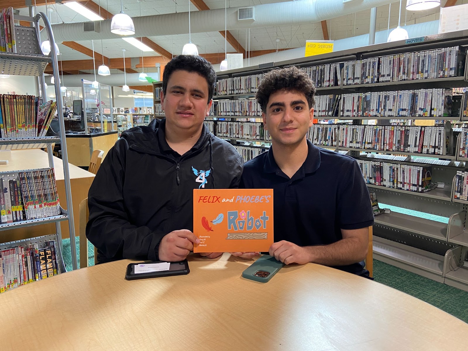 Students from High Tech High School Robotics Club, Idan (left) and Eliran (right) holding up their self-published children's book, Felix and Phoebe's Robot.